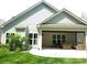Back of house with outdoor patio, living space, and lush green lawn at 1311 Stonecroft Nw Ln, Concord, NC 28027