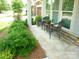 Inviting front porch with seating area and lush landscaping at 1311 Stonecroft Nw Ln, Concord, NC 28027