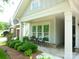 Inviting front porch with seating area and lush landscaping at 1311 Stonecroft Nw Ln, Concord, NC 28027