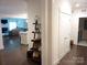 Hallway leading to living room and kitchen featuring dark hardwood floors and white trim at 1311 Stonecroft Nw Ln, Concord, NC 28027
