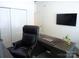 Home office featuring a large dark wooden desk and executive chair, with a wall-mounted TV at 1311 Stonecroft Nw Ln, Concord, NC 28027