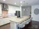 Modern kitchen with stainless steel appliances, granite countertops, and a large island at 1311 Stonecroft Nw Ln, Concord, NC 28027