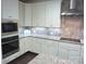 Modern kitchen with stainless steel appliances, granite countertops, and ample cabinet space at 1311 Stonecroft Nw Ln, Concord, NC 28027