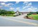 Brick home with well-maintained landscaping, a driveway, and a glimpse of the surrounding neighborhood at 1410 Patterson St, China Grove, NC 28023