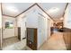 Inviting hallway with wood paneling, bi-fold closet doors, and access to other rooms at 1410 Patterson St, China Grove, NC 28023