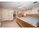 Spacious main bedroom with view to bathroom, natural wood furniture, ceiling fan, and carpet at 1410 Patterson St, China Grove, NC 28023