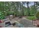 Beautiful outdoor patio with stone pavers, a built-in BBQ, a fountain, and outdoor seating at 14652 Villalonga Ln, Charlotte, NC 28277