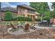 Enjoy a spacious backyard with a stone fire pit, outdoor dining, a lounge area and manicured landscaping at 14652 Villalonga Ln, Charlotte, NC 28277