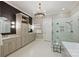 Modern bathroom with double sink, large vanity and bathtub with a glass enclosed shower at 14652 Villalonga Ln, Charlotte, NC 28277