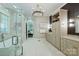 Modern bathroom with double sink, large vanity and bathtub with a glass enclosed shower at 14652 Villalonga Ln, Charlotte, NC 28277