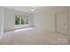 Spacious and airy bedroom with large window overlooking a green space and neutral carpeting at 14652 Villalonga Ln, Charlotte, NC 28277