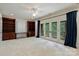 Bonus room with custom wood bookshelves, french doors, and a ceiling fan at 14652 Villalonga Ln, Charlotte, NC 28277