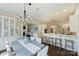 Open floor plan with dining table and kitchen bar with dark wood floors and white cabinets at 14652 Villalonga Ln, Charlotte, NC 28277