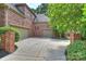 Long concrete driveway with three garages and brick exterior accents at 14652 Villalonga Ln, Charlotte, NC 28277