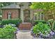Charming home entrance with brick steps, lush landscaping, and a beautiful wood and glass front door at 14652 Villalonga Ln, Charlotte, NC 28277