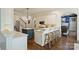 Well-appointed kitchen features white cabinets, contrasting blue island, stainless steel appliances, and bar seating at 14652 Villalonga Ln, Charlotte, NC 28277