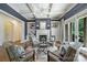Inviting living room with coffered ceiling, fireplace flanked by built-ins, and elegant seating arrangement at 14652 Villalonga Ln, Charlotte, NC 28277