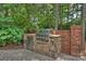 Stone outdoor kitchen with built-in BBQ, storage, counter space, and easy access to the backyard at 14652 Villalonga Ln, Charlotte, NC 28277