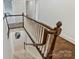 Staircase with hardwood floors, a white railing, and carpeted stairs leading to the upper level at 14652 Villalonga Ln, Charlotte, NC 28277