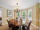 Bright dining room featuring a wooden table, chandelier, and natural light from surrounding windows at 1518 Appaloosa Way, Gastonia, NC 28056