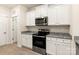 Well-equipped kitchen with stainless steel appliances, granite countertops, and white cabinetry offering ample storage at 1518 Doran Ter, Richburg, SC 29729