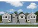 New two-story townhomes featuring multi-car garages, dormer windows, and modern exterior in a residential neighborhood at 172 Quartz Hill Way, Waxhaw, NC 28173