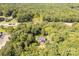 Aerial view of a charming home surrounded by lush greenery next to HWY 521, showcasing its peaceful and accessible location at 1738 Charlotte Hwy, Lancaster, SC 29720