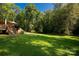 Large, lush backyard offering ample space for recreation and relaxation, with mature trees providing shade at 1738 Charlotte Hwy, Lancaster, SC 29720