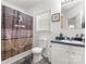 Cozy bathroom with a shower, toilet, and sink with white cabinets and blue countertops at 1738 Charlotte Hwy, Lancaster, SC 29720