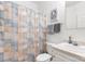 Well-lit bathroom featuring a shower, toilet, and sink with white cabinets and tan countertops at 1738 Charlotte Hwy, Lancaster, SC 29720