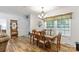 Dining room featuring a glass table, decorative window treatments, and wood flooring at 1738 Charlotte Hwy, Lancaster, SC 29720
