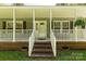 Inviting covered front porch with brick foundation, steps, and white railings at 1738 Charlotte Hwy, Lancaster, SC 29720