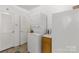 Laundry room featuring a stacked washer and dryer next to the refrigerator at 1738 Charlotte Hwy, Lancaster, SC 29720