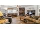 Cozy living room with a stone fireplace, ceiling fan and wood-look floors at 1738 Charlotte Hwy, Lancaster, SC 29720