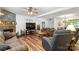 Spacious living room featuring a stone fireplace, wood-look floors, and a large TV at 1738 Charlotte Hwy, Lancaster, SC 29720