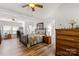 Spacious main bedroom with a ceiling fan, wood-look flooring, and an attached office and bath at 1738 Charlotte Hwy, Lancaster, SC 29720