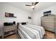 Comfortable bedroom with a ceiling fan, wood floors, shiplap accent wall, and side table at 18679 Vineyard Point Ln, Cornelius, NC 28031