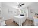 Inviting bedroom with natural light, ceiling fan, wood flooring, and decorative shelving at 18679 Vineyard Point Ln, Cornelius, NC 28031