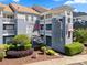 The exterior of this condo features beautiful landscaping and charming balcony, perfect for relaxing outdoors at 18679 Vineyard Point Ln, Cornelius, NC 28031