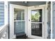 Close-up of the front door, with a stylish storm door and welcoming decor, providing a charming entrance at 18679 Vineyard Point Ln, Cornelius, NC 28031