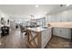 Open concept kitchen featuring an island with wooden accents and stainless steel appliances at 18679 Vineyard Point Ln, Cornelius, NC 28031