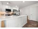 Bright, white kitchen with stainless steel appliances, sleek countertops, and ample cabinet space at 18679 Vineyard Point Ln, Cornelius, NC 28031