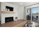 A living room with a fireplace, television, decor, rug, and sliding doors leading to a patio at 18679 Vineyard Point Ln, Cornelius, NC 28031