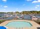 Scenic view of the pool and marina area with boats and waterfront homes at 18679 Vineyard Point Ln, Cornelius, NC 28031