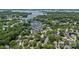 Aerial view of waterfront community with lush trees, showcasing lake access and neighborhood charm at 19746 Valiant Way, Cornelius, NC 28031