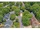 Aerial view of a home nestled amongst lush green trees in a quiet neighborhood at 19746 Valiant Way, Cornelius, NC 28031