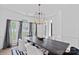 Formal dining room with a modern chandelier, large table, and stylish decor at 19746 Valiant Way, Cornelius, NC 28031
