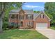 Beautiful brick home with a well-manicured lawn and a two-car garage at 19746 Valiant Way, Cornelius, NC 28031
