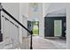 Bright, grand foyer with staircase, high ceilings, and an open front door at 19746 Valiant Way, Cornelius, NC 28031