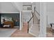 Elegant foyer featuring a staircase, dark accent wall, and wood flooring at 19746 Valiant Way, Cornelius, NC 28031